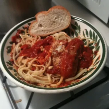 Linguine topped with old style Italian gravy, sausage, and grated cheese, served with a slice of Italian bread.
