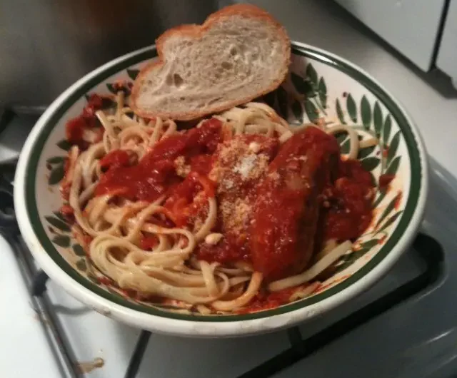 Linguine topped with old style Italian gravy, sausage, and grated cheese, served with a slice of Italian bread.