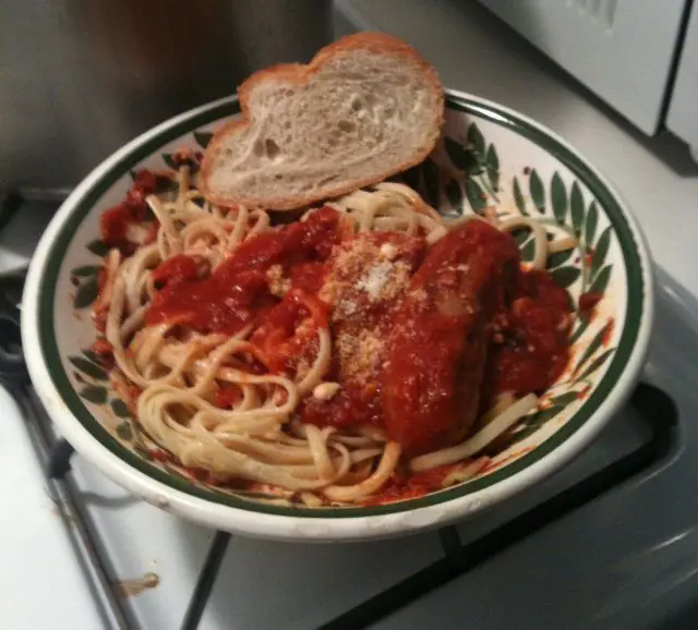 Linguine topped with old style Italian gravy, sausage, and grated cheese, served with a slice of Italian bread.