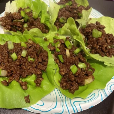 Crisp butter-lettuce cups filled with saucy ground beef and topped with chopped green onions