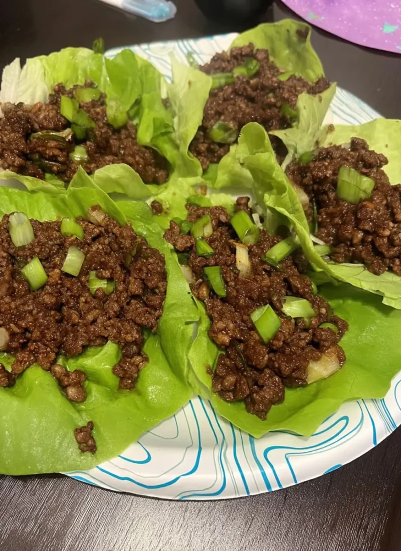 Crisp butter-lettuce cups filled with saucy ground beef and topped with chopped green onions
