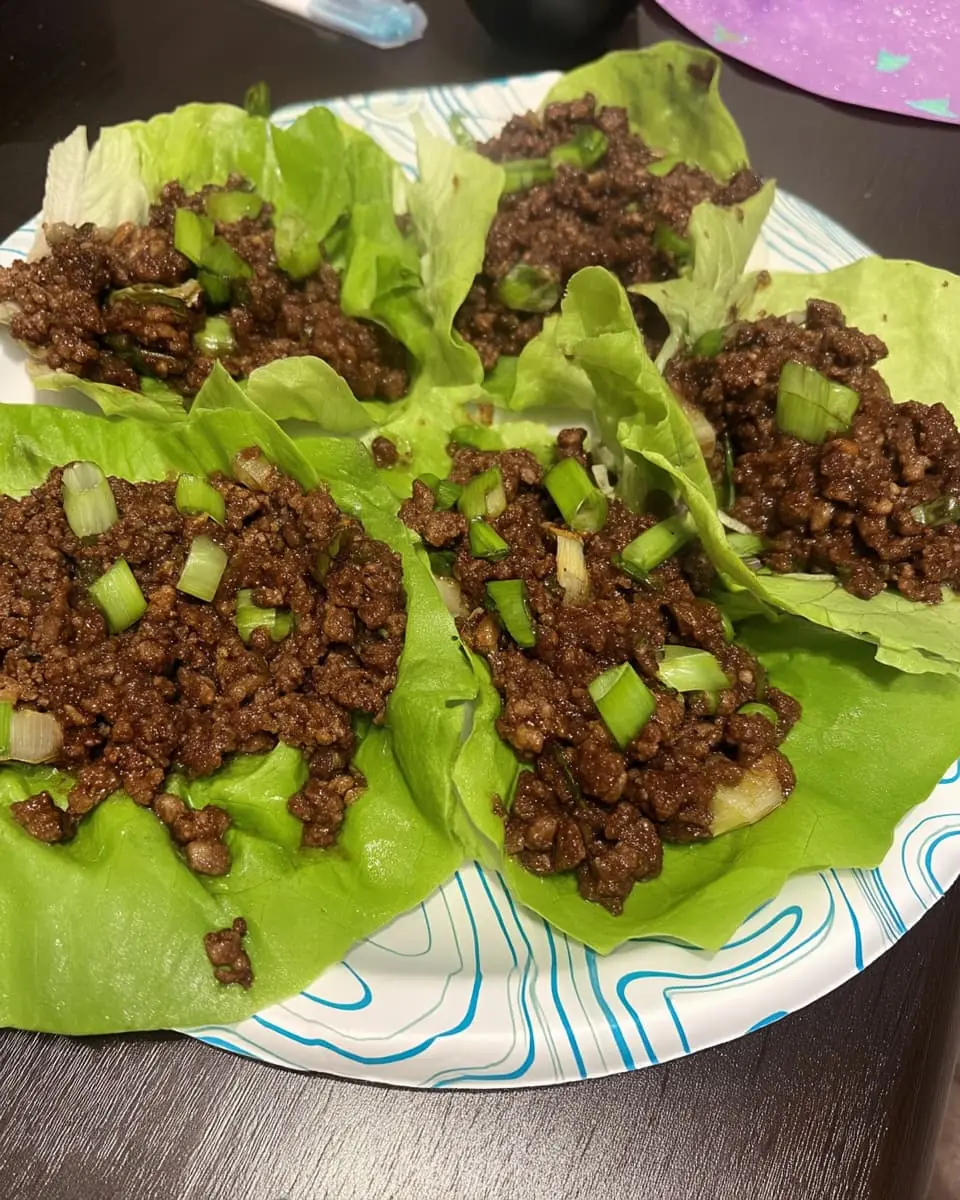Crisp butter-lettuce cups filled with saucy ground beef and topped with chopped green onions